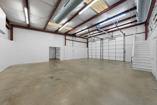Warehouse interior with concrete floor and roll-up doors at 1320 Old Oxford Road